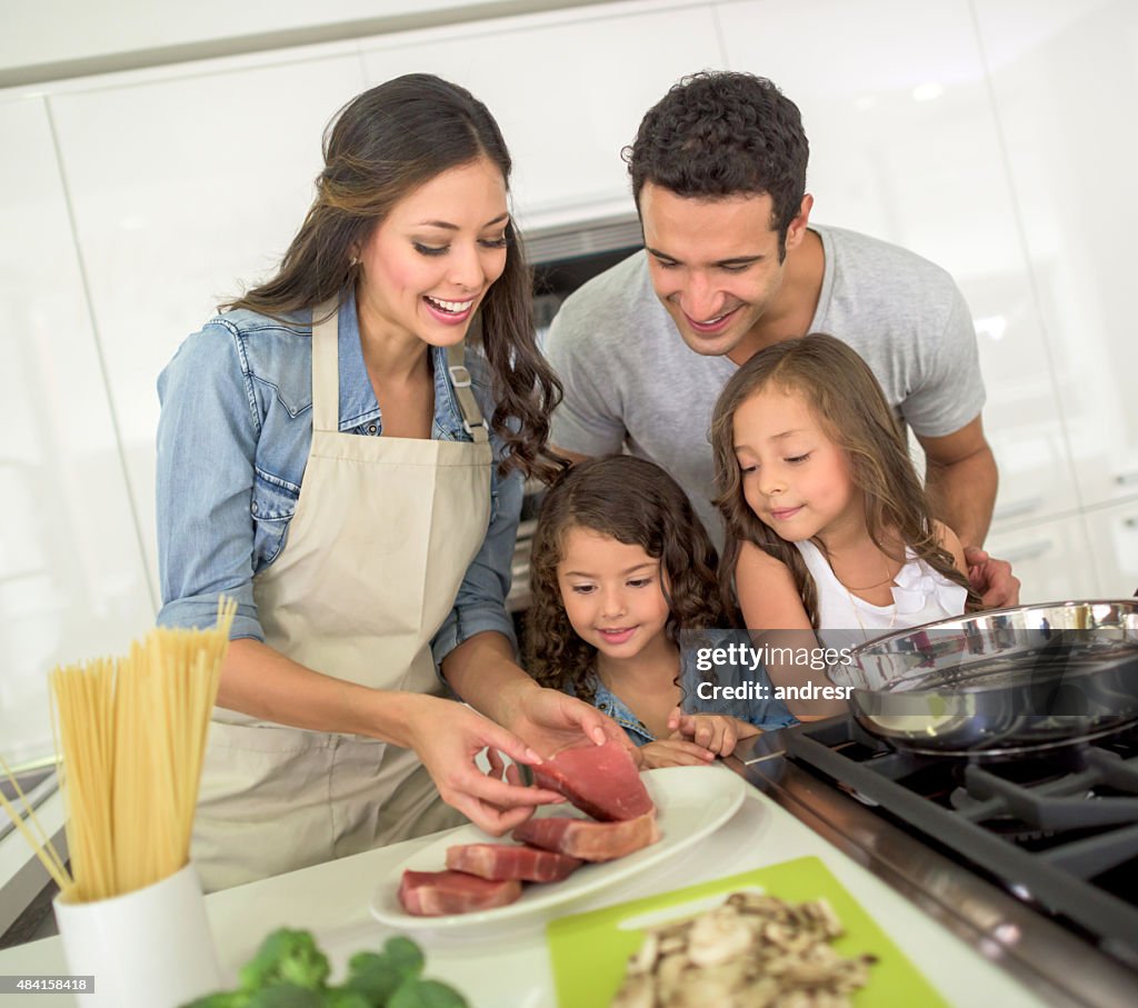 Happy family cooking dinner together