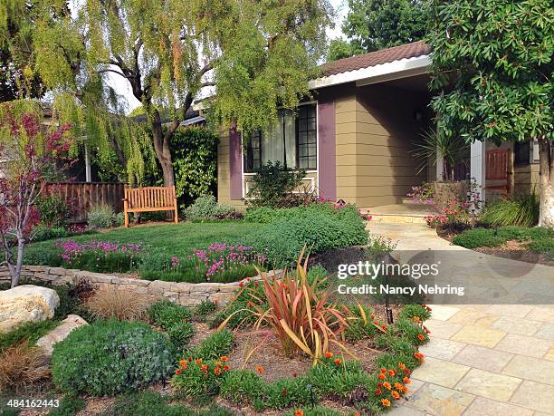 Beautifully landscaped front yard of suburban tract house adds a personal touch to a neighborhood of similar houses. House built about 1970....