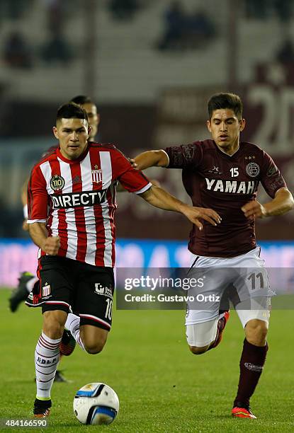 David Barbona of Estudiantes and Jorge Valdez Chamorro of Lanus fight for the ball during a match between Lanus and Estudiantes as part of 20th round...