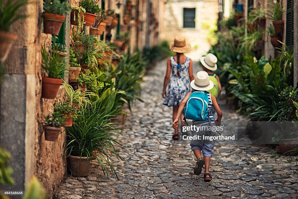 Kids walking in mediterranean street.