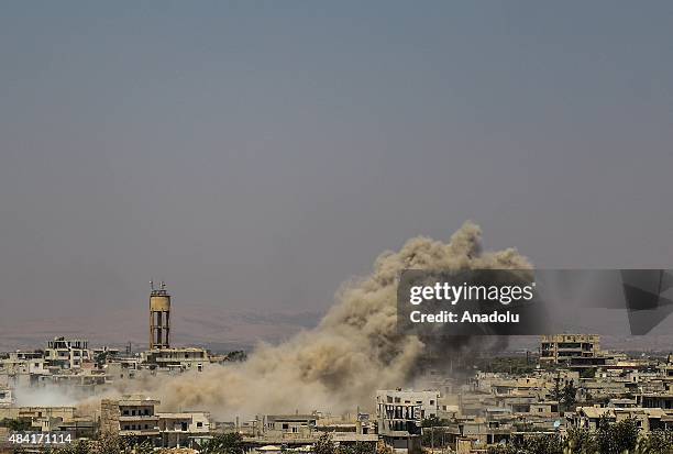 Smoke rises from a building belongs to Assad regime forces after the Syrian opposition groups linked to Ahrar al Sham troops' attack in al-Fua town...