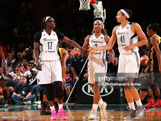 Essence Carson hi fives Kiah Stokes and Candice Wiggins of the New York Liberty on August 15, 2015 at Madison Square Garden, New York City , New...