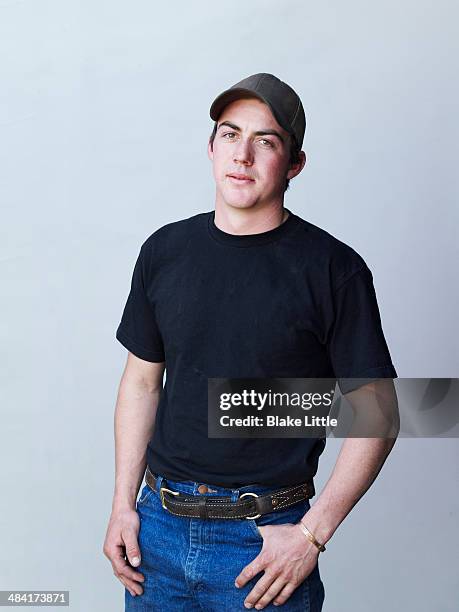 young male feedlot worker w ball cap - man cap stock pictures, royalty-free photos & images