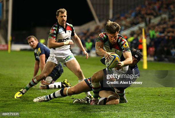 Sam Smith of Harlequins beats a tackle from Andrei Ostrikov of Sale Sharks to score a try during the Aviva Premiership match between Sale Sharks and...