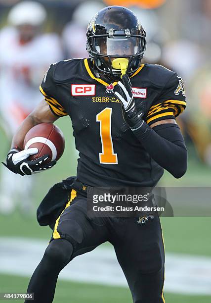 Tiquan Underwood of the Hamilton Tiger-Cats runs with a long reception for a touchdown against the BC Lions during a CFL football game at Tim Hortons...