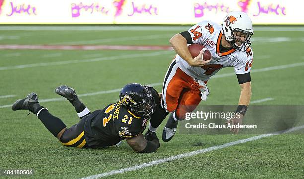 Simoni Lawrence of the Hamilton Tiger-Cats sacks Travis Lulay of the BC Lions during a CFL football game at Tim Hortons Field on August 15, 2015 in...