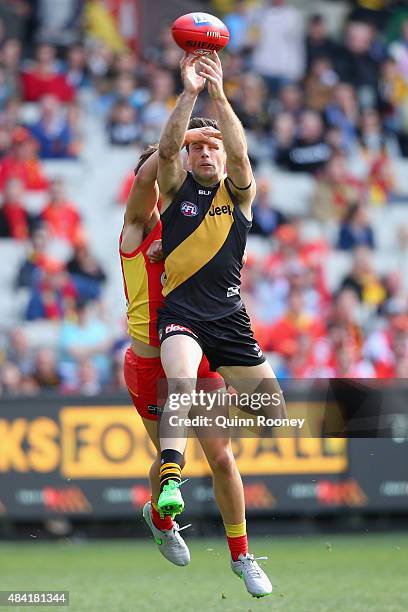 Trent Cotchin of the Tigers marks infront of Kade Kolodjashnij of the Suns during the round 20 AFL match between the Richmond Tigers and the Gold...