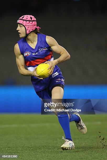 Heather Anderson of the Bulldogs runs with the ball during a Women's AFL exhibition match between Western Bulldogs and Melbourne at Etihad Stadium on...