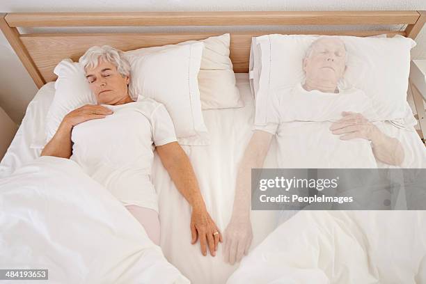 the bed feels so empty without him there... - widow pension stock pictures, royalty-free photos & images