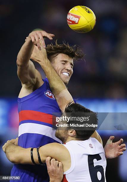 Marcus Bontempelli of the Bulldogs wins the tap out over Chris Dawes of the Demons during the round 20 AFL match between the Western Bulldogs and...