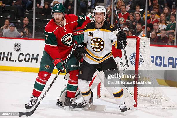 Jonathan Blum of the Minnesota Wild and Daniel Paille of the Boston Bruins battle for position during the game on April 8, 2014 at the Xcel Energy...