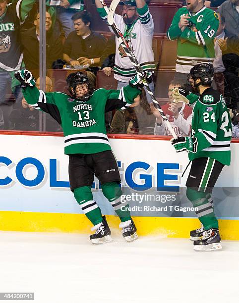 Connor Gaarder of North Dakota celebrates his goal against the Minnesota Golden Gophers with teammate Jordan Schmaltz during the NCAA Division I...