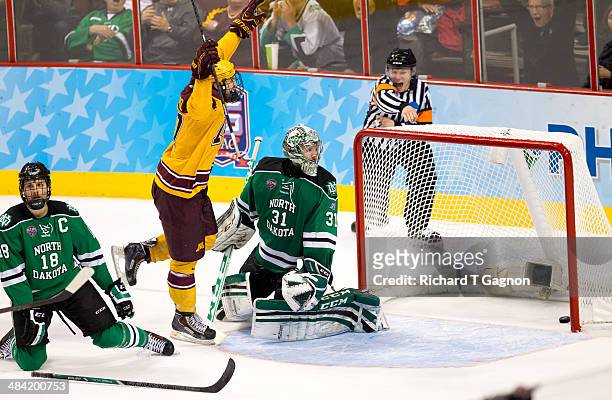 Seth Ambroz of the Minnesota Golden Gophers reacts as the puck is in the net on a goal by teammate Justin Holl with only .6 seconds remaining as Zane...