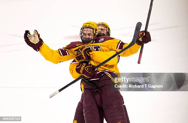 Seth Ambroz of the Minnesota Golden Gophers picks up teammate Justin Holl after Holl scored the game winning goal against North Dakota with only .6...