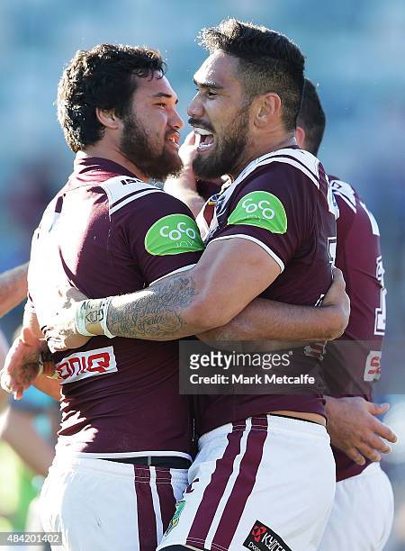 Jesse Sene-Lefao and Feleti Mateo of the Sea Eagles celebrate victory in the round 23 NRL match between the Canberra Raiders and the Manly Warringah...