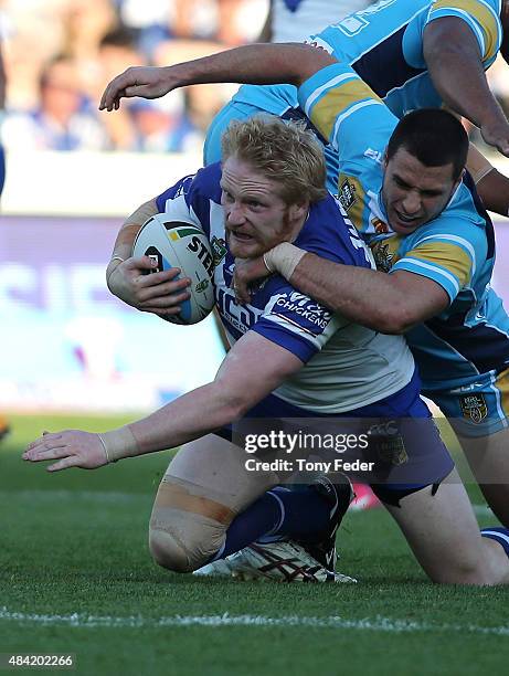 James Graham of the Bulldogs is tackled during the round 23 NRL match between the Canterbury Bulldogs and the Gold Coast Titans at Central Coast...