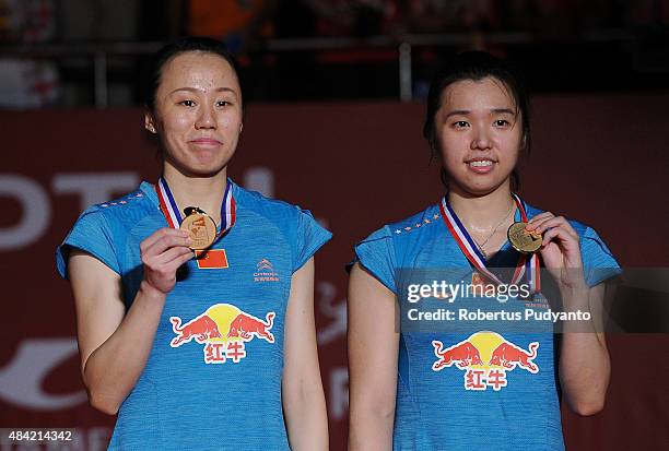 Tian Qing and Zhao Yunlei of China celebrate on the podium in the women doubles awarding ceremony of the 2015 Total BWF World Championship at Istora...