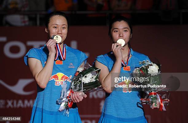 Tian Qing and Zhao Yunlei of China celebrate on the podium in the women doubles awarding ceremony of the 2015 Total BWF World Championship at Istora...