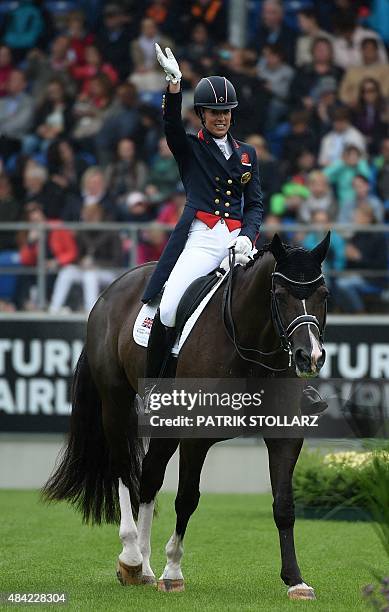 Gold medal winner Charlotte Dujardin of Great Britain waves after the Grand Prix Freestyle Dressage Individual Final during the FEI European...