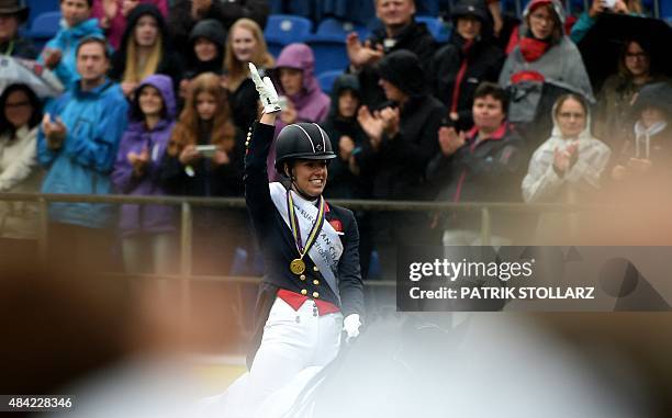 Gold medal winner Charlotte Dujardin of Great Britain reacts after the Grand Prix Freestyle Dressage Individual Final during the FEI European...