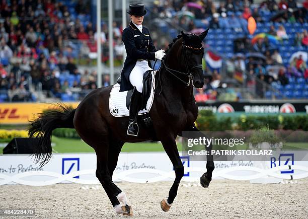 Kristina Broering-Sprehe of Germany on her horse Desperados competes during the Grand Prix Freestyle Dressage Individual Final during the FEI...