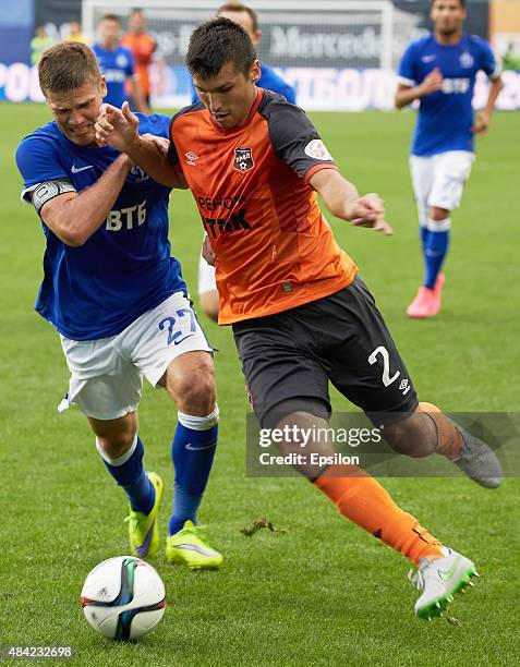 Igor Denisov of FC Dinamo Moscow is challenged by Vladimir Hozin of FC Ural Sverdlovsk Oblast during the Russian Premier League match between Dinamo...