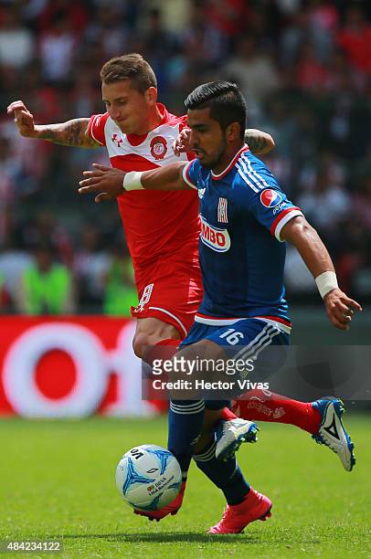 Miguel Ponce of Chivas struggles for the ball with Dario Bottinelli of Toluca during a 5th round match between Toluca and Chivas as part of the...