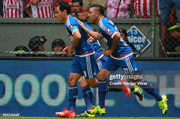 Omar Bravo of Chivas celebrates with his teammates after scoring the first goal of his team during a 5th round match between Toluca and Chivas as...