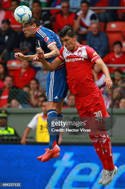 Jorge Enriquez of Chivas struggles for the ball with Jordan Silva of Toluca during a 5th round match between Toluca and Chivas as part of the...