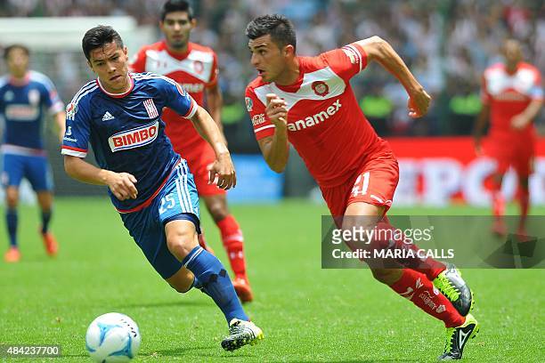 Enrique Triverio of Toluca vies for the ball with Michael Perez of Guadalajara during their Mexican Apertura tournament football match at the Nemesio...