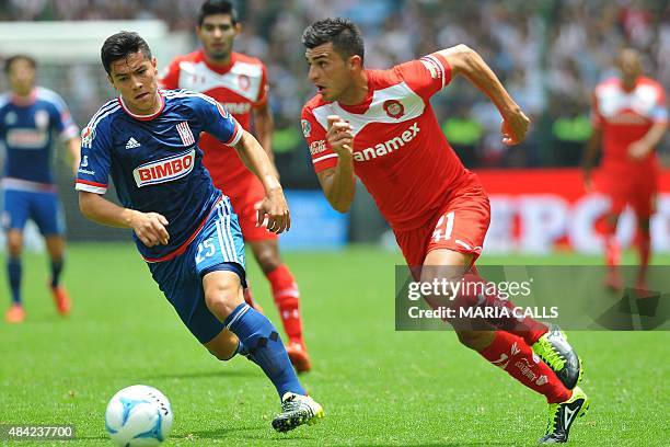 Enrique Triverio of Toluca vies for the ball with Michael Perez of Guadalajara during their Mexican Apertura tournament football match at the Nemesio...