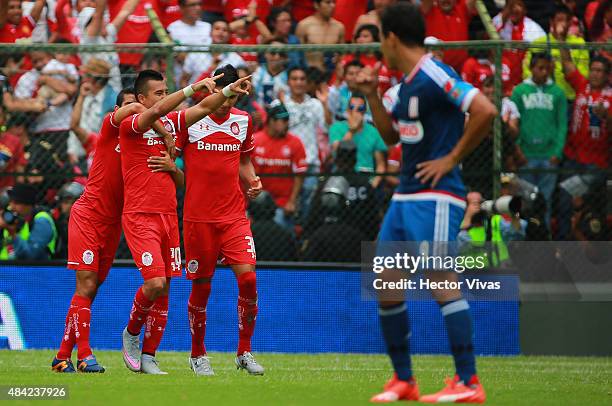 Fernando Uribe of Toluca celebrates with teammates after scoring the third goal of his team during a 5th round match between Toluca and Chivas as...