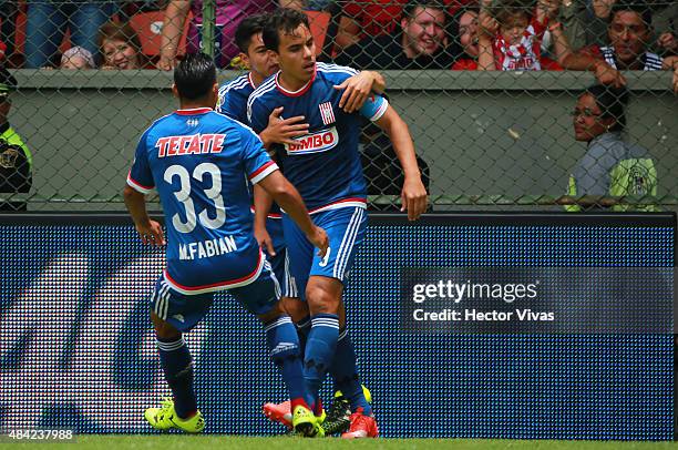 Omar Bravo of Chivas celebrates with his teammates after scoring the first goal of his team during a 5th round match between Toluca and Chivas as...