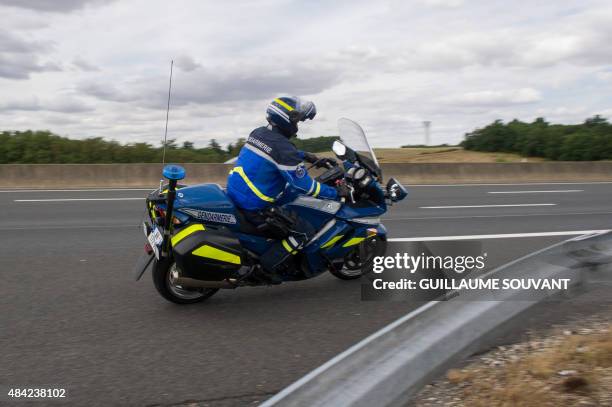 French Gendarme on a motorbike prepares to intercept a car on August 16 near the tollgate of Monnaie on the A10 highway. French policemen will...