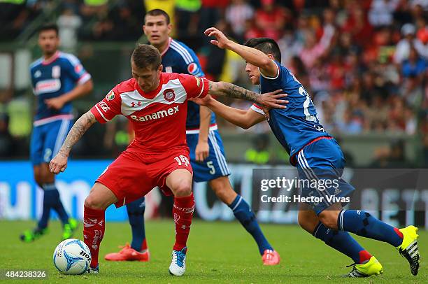 Michael Perez of Chivas struggles for the ball with Dario Bottinelli of Toluca during a 5th round match between Toluca and Chivas as part of the...