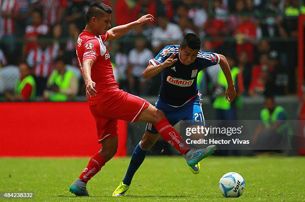 Jose Ramirez of Chivas struggles for the ball with Fernando Uribe of Toluca during a 5th round match between Toluca and Chivas as part of the...