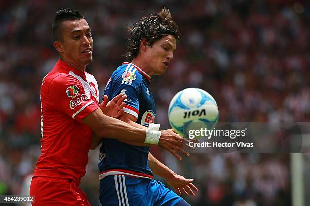 Carlos Fierro of Chivas fights for the ball with Fernando Uribe of Toluca during a 5th round match between Toluca and Chivas as part of the Apertura...