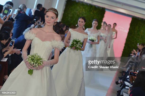 Models walk the runway at the Oscar De La Renta Spring 2015 Bridal collection show on April 11, 2014 in New York City.