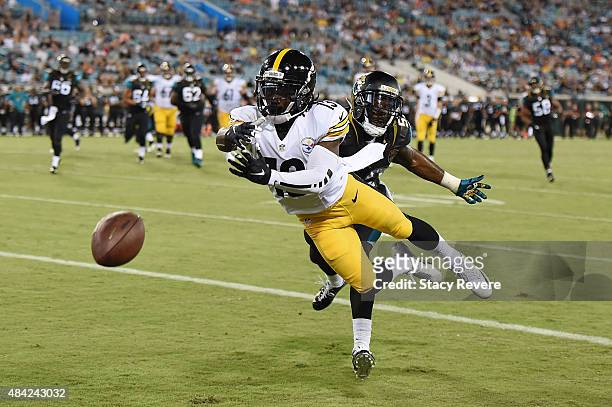Dri Archer of the Pittsburgh Steelers is unable to catch a pass in front of LaRoy Reynolds of the Jacksonville Jaguars during a preseason game at...