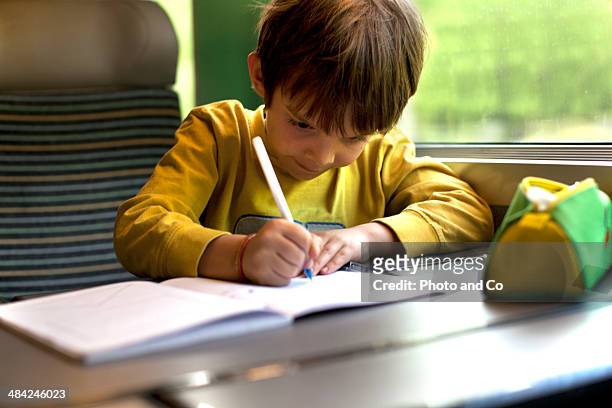 child writing on the train - co writer stock pictures, royalty-free photos & images