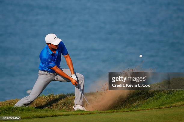Jordan Spieth of the United States plays a bunker shot on the 16th hole during the final round of the 2015 PGA Championship at Whistling Straits on...
