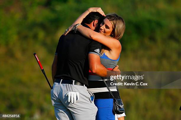 Jason Day of Australia celebrates on the 18th green with his wife Ellie after winning the 2015 PGA Championship with a score of 20-under par at...