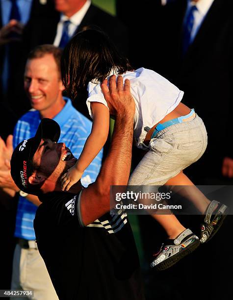 Jason Day of Australia celebrates with his son Dash after winning the 2015 PGA Championship with a score of 20-under par at Whistling Straits on...