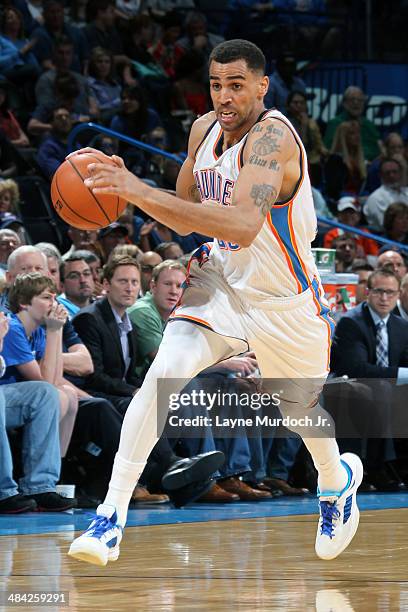 Thabo Sefolosha of the Oklahoma City Thunder handles the ball against the New Orleans Pelicans on April 11, 2014 at the Chesapeake Energy Arena in...