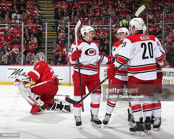 Detroit Red Wings goalie Jimmy Howard gets up off the ice as Carolina Hurricanes left wing Jeff Skinner, center Riley Nash and center Andrei...