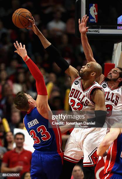 Taj Gibson of the Chicago Bulls blocks a shot by Jonas Jerebko of the Detroit Pistons at the United Center on April 11, 2014 in Chicago, Illinois....