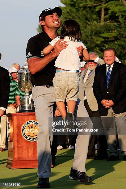 Jason Day of Australia celebrates with his son Dash after winning the 2015 PGA Championship with a score of 20-under par at Whistling Straits on...