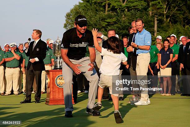 Jason Day of Australia celebrates with his son Dash after winning the 2015 PGA Championship with a score of 20-under par at Whistling Straits on...