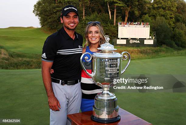 Jason Day of Australia poses with his wife and the Wanamaker Trophy after winning the 2015 PGA Championship with a score of 20-under par at Whistling...