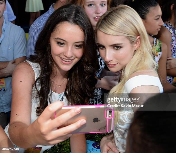 Actress Emma Roberts takes a selfie with a fan at the Teen Choice Awards 2015 at the USC Galen Center on August 16, 2015 in Los Angeles, California.